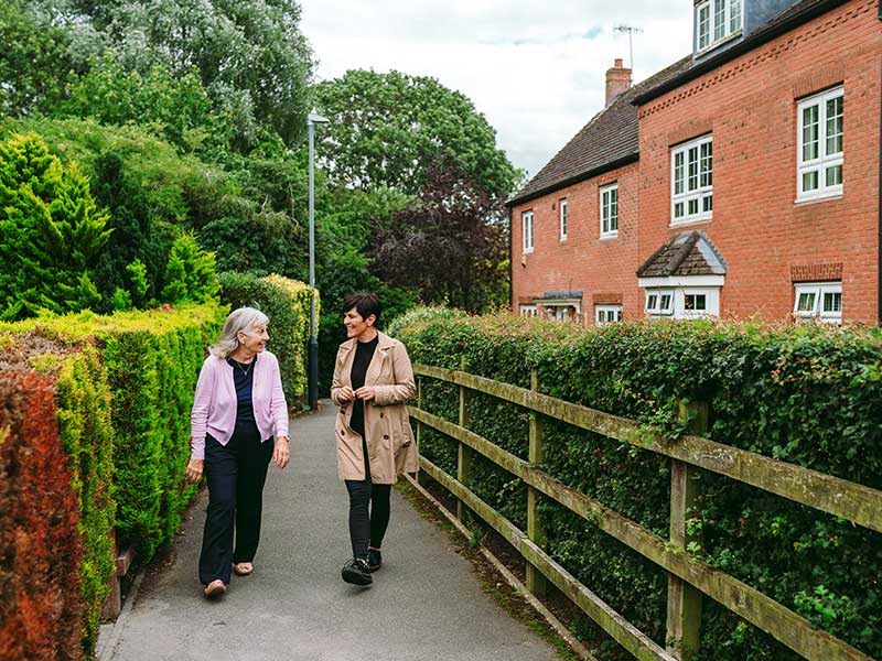 Two people walking down path
