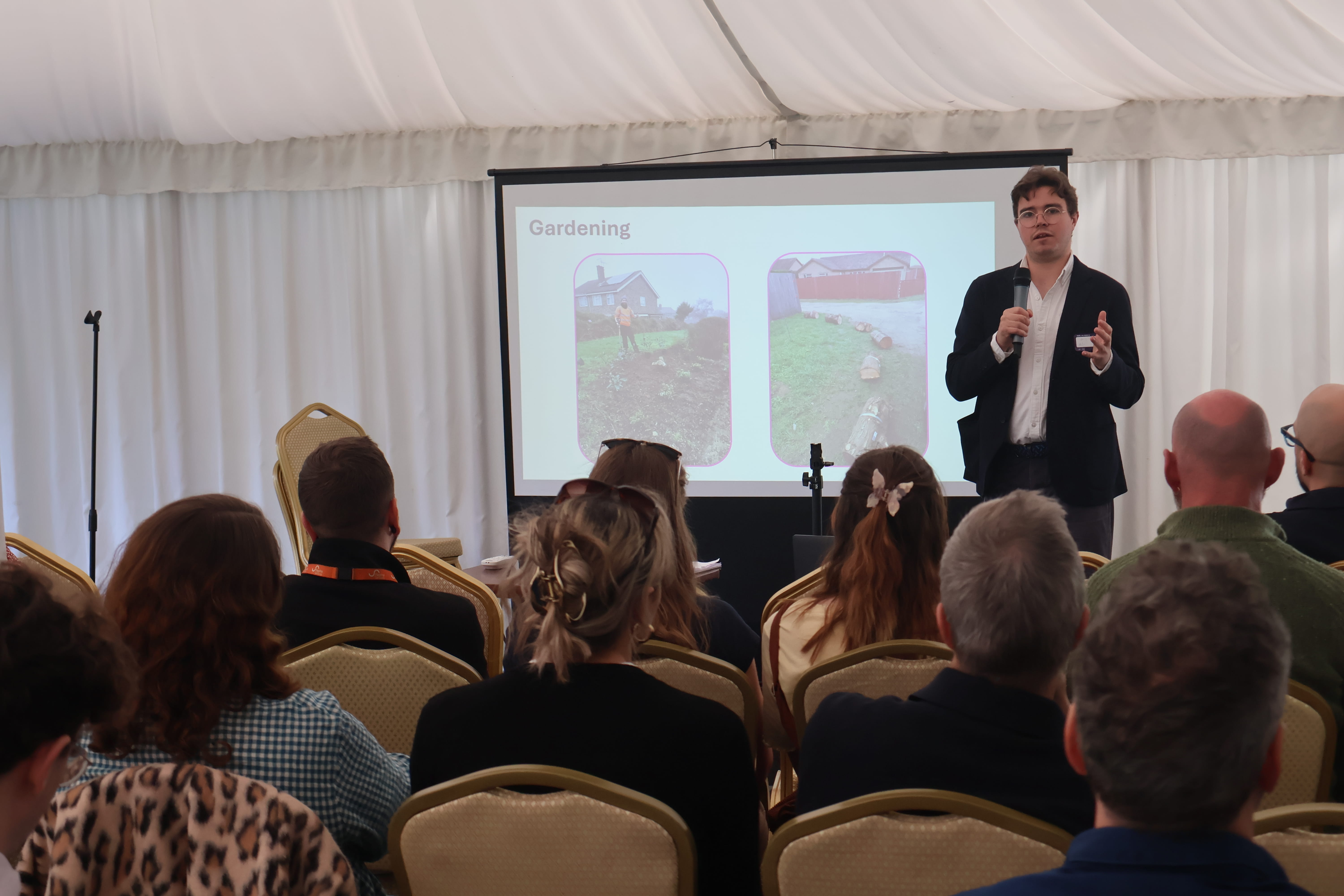 Daniel Salliss (BFL) gives an update on the organisation's biodiversity projects in the east of England to the audience at the 'Nature in Housing' summit, to mark Earth Day 2026